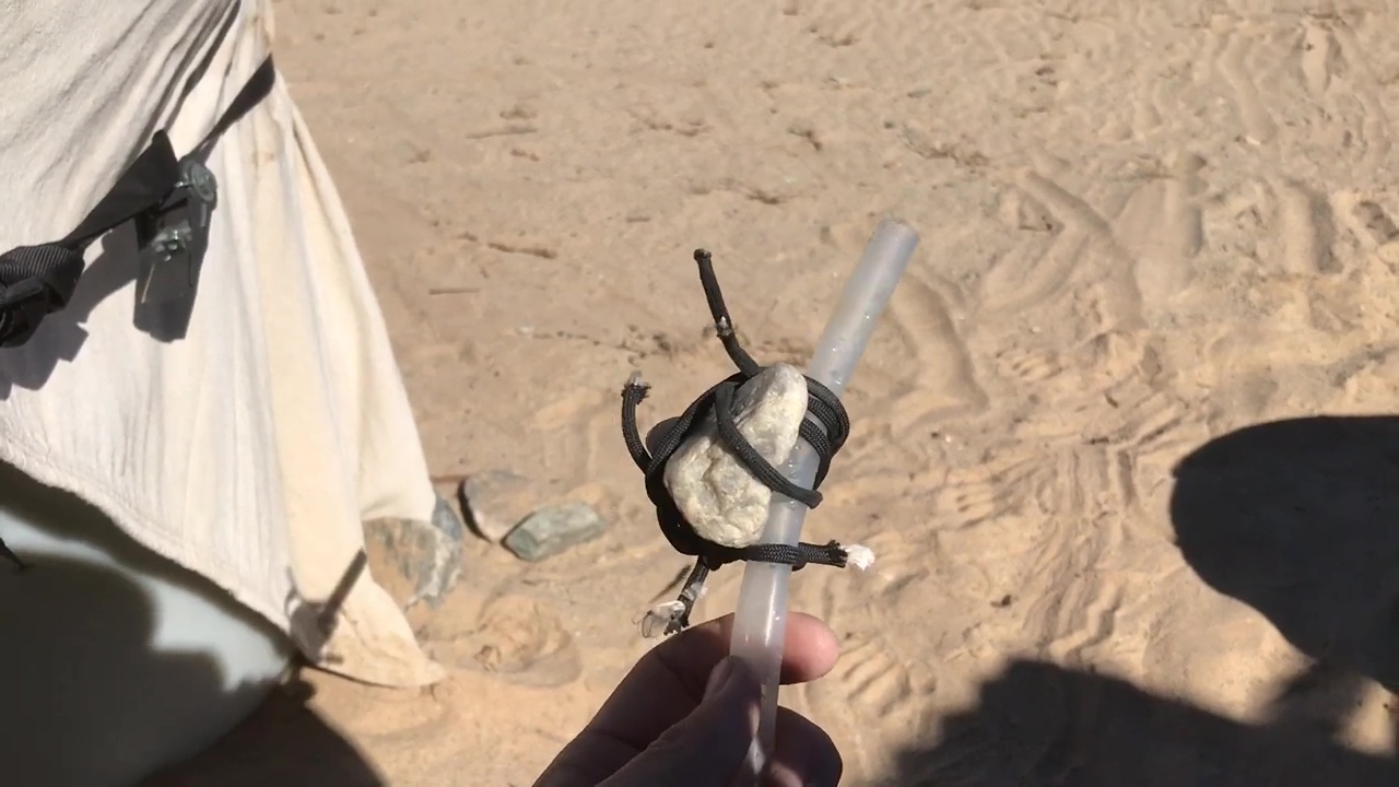 01 Tying Rock To Silicone Tube To Weigh It Down As A Sinker Into 55 Gallon Drum Water Tank