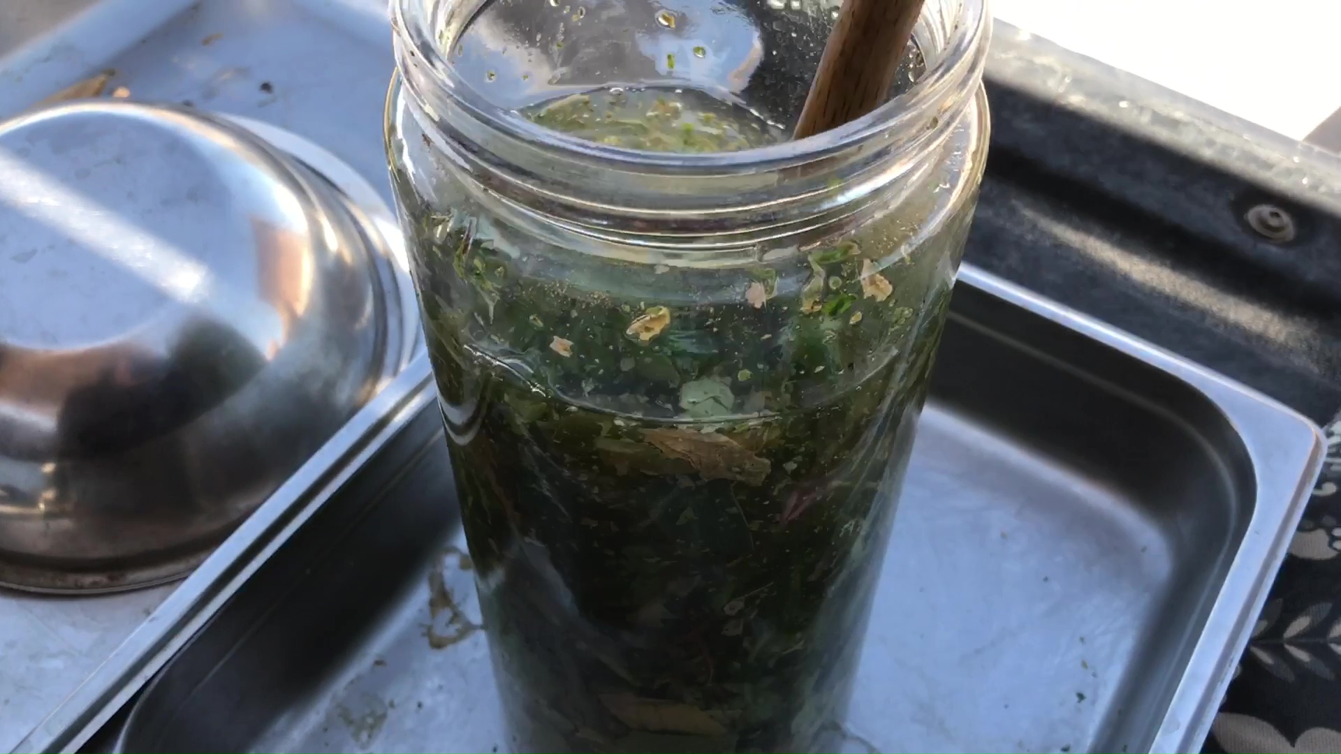 03 Fresh Greens And Herbs Stirred Into Salt Brine Fermentation Jar