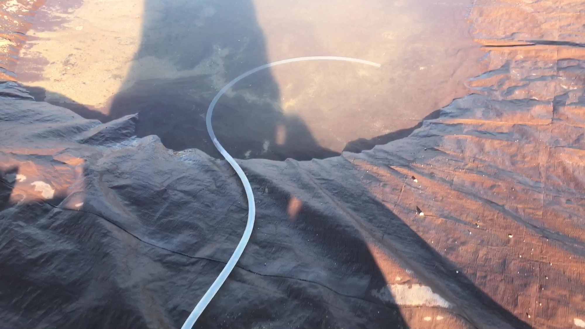 04 Dropping Water Filled Tube Into Rain Water Tarp Catchment Pond