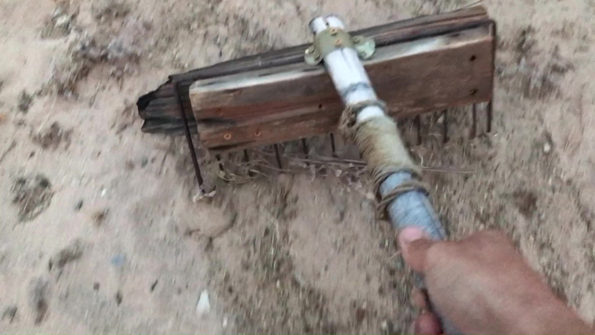 04 Raking Desert Weeds With A Bamboo And Rusted Grill Rake