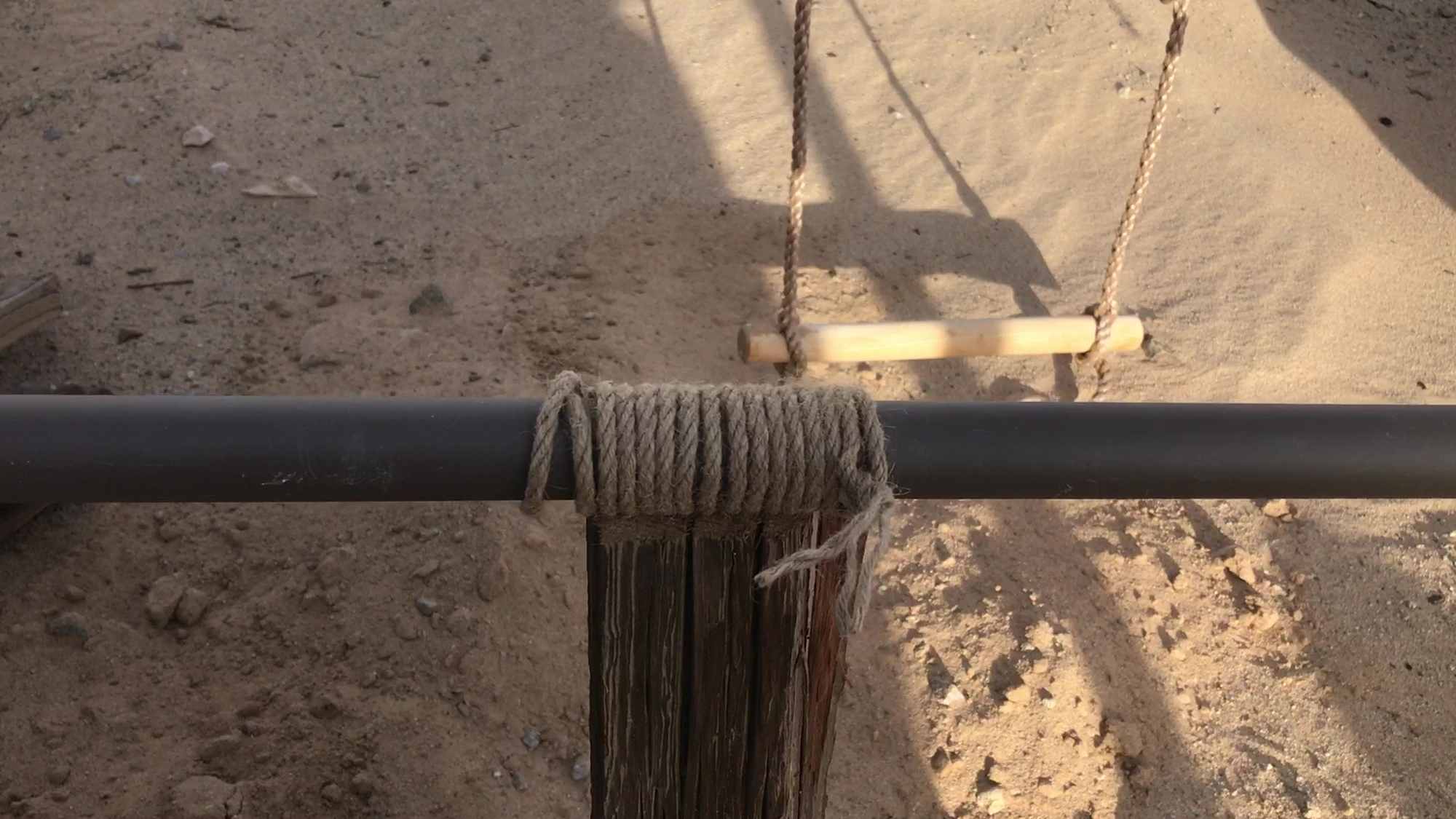 Scavenged Scrap Wood Structural In Ground Support Beam Anchor to Resist Desert Sand and Wind Storms 01 Top of Anchor With Rope