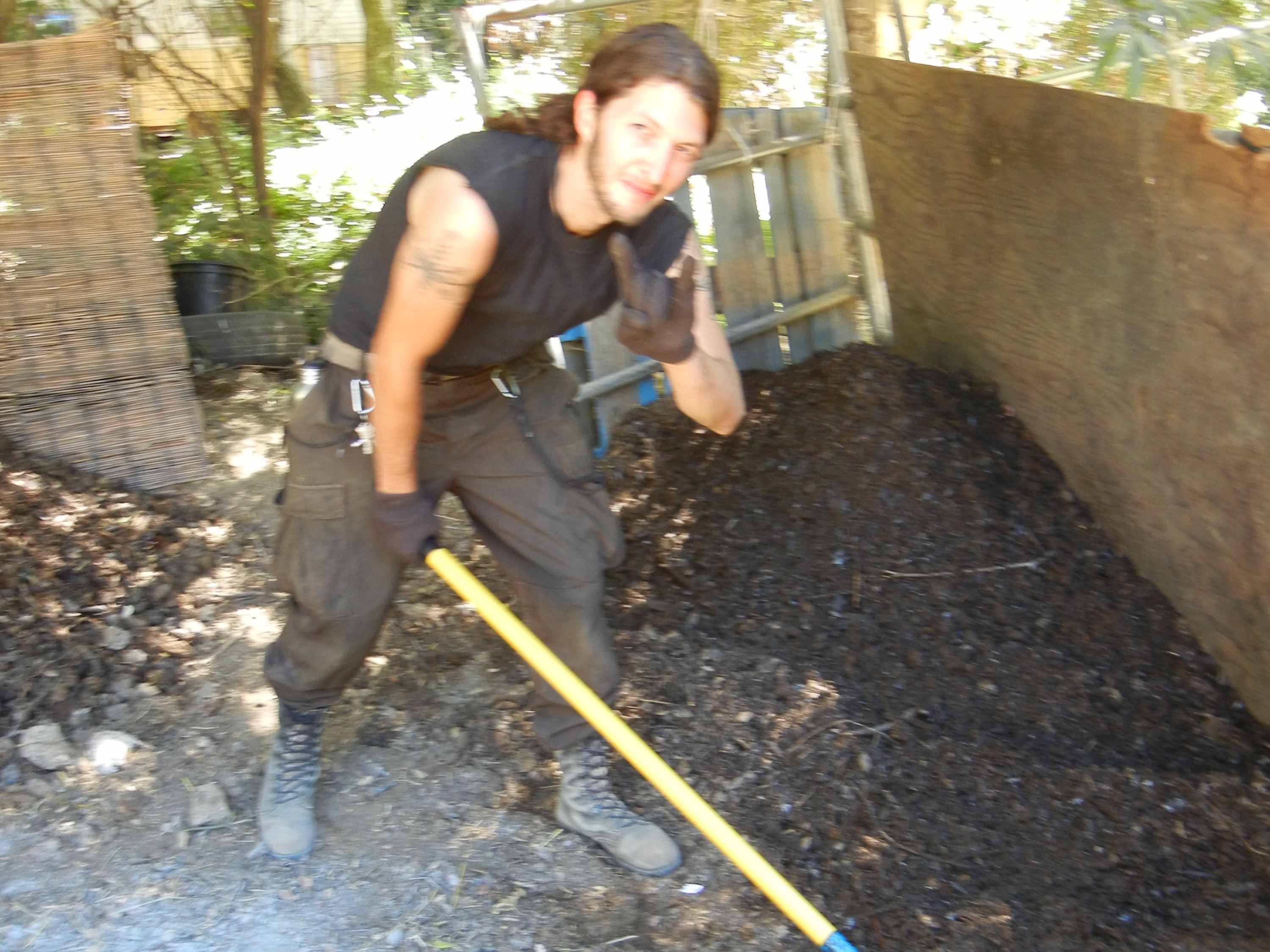 Turning Horse Manure Compost Pile Next To Horse Corral